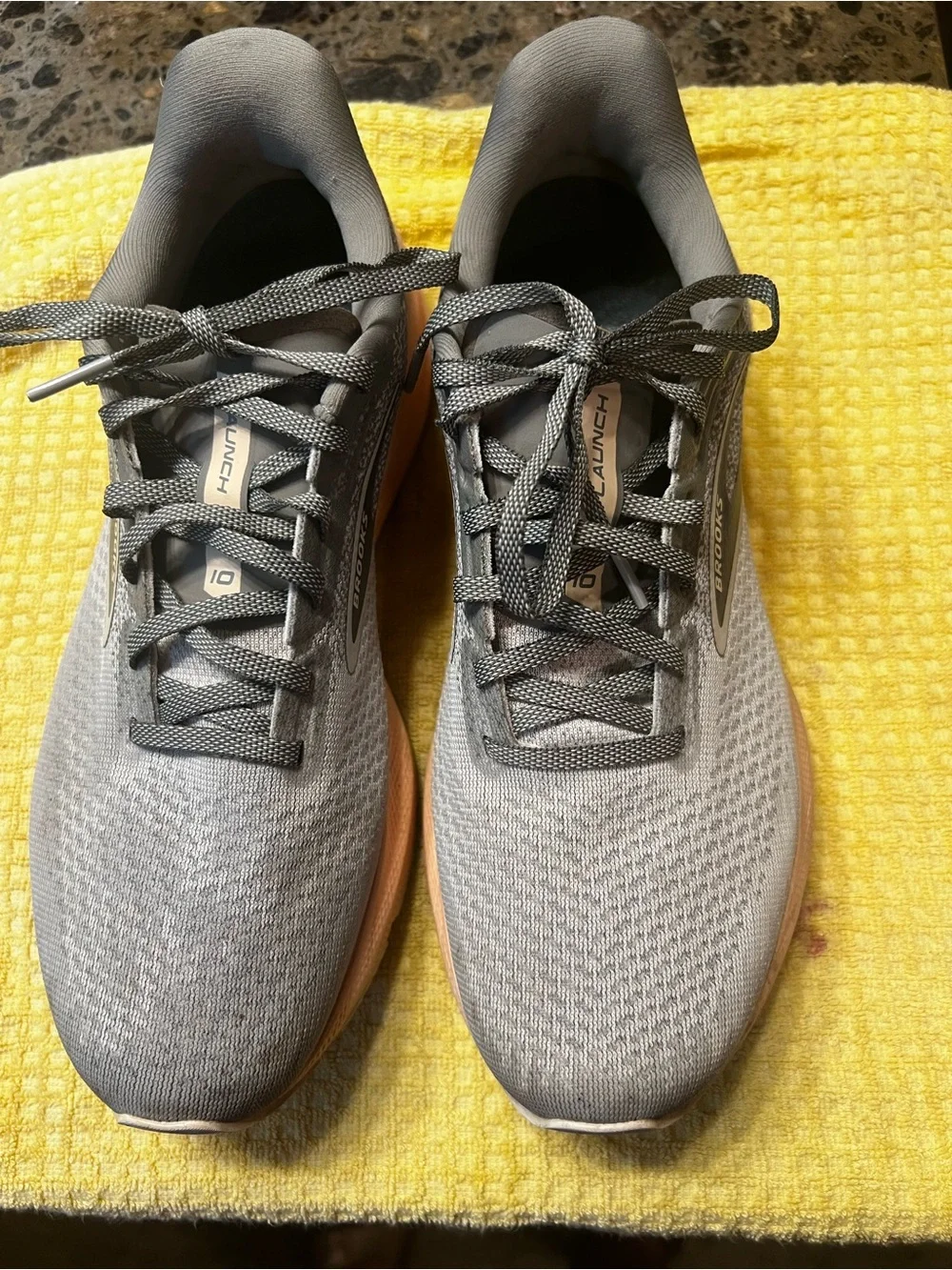 Brooks gray running shoes with pinkish peach midsole